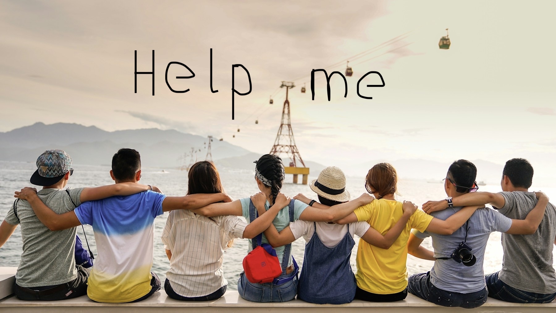 Eight friends sitting side by side with their arms around one another